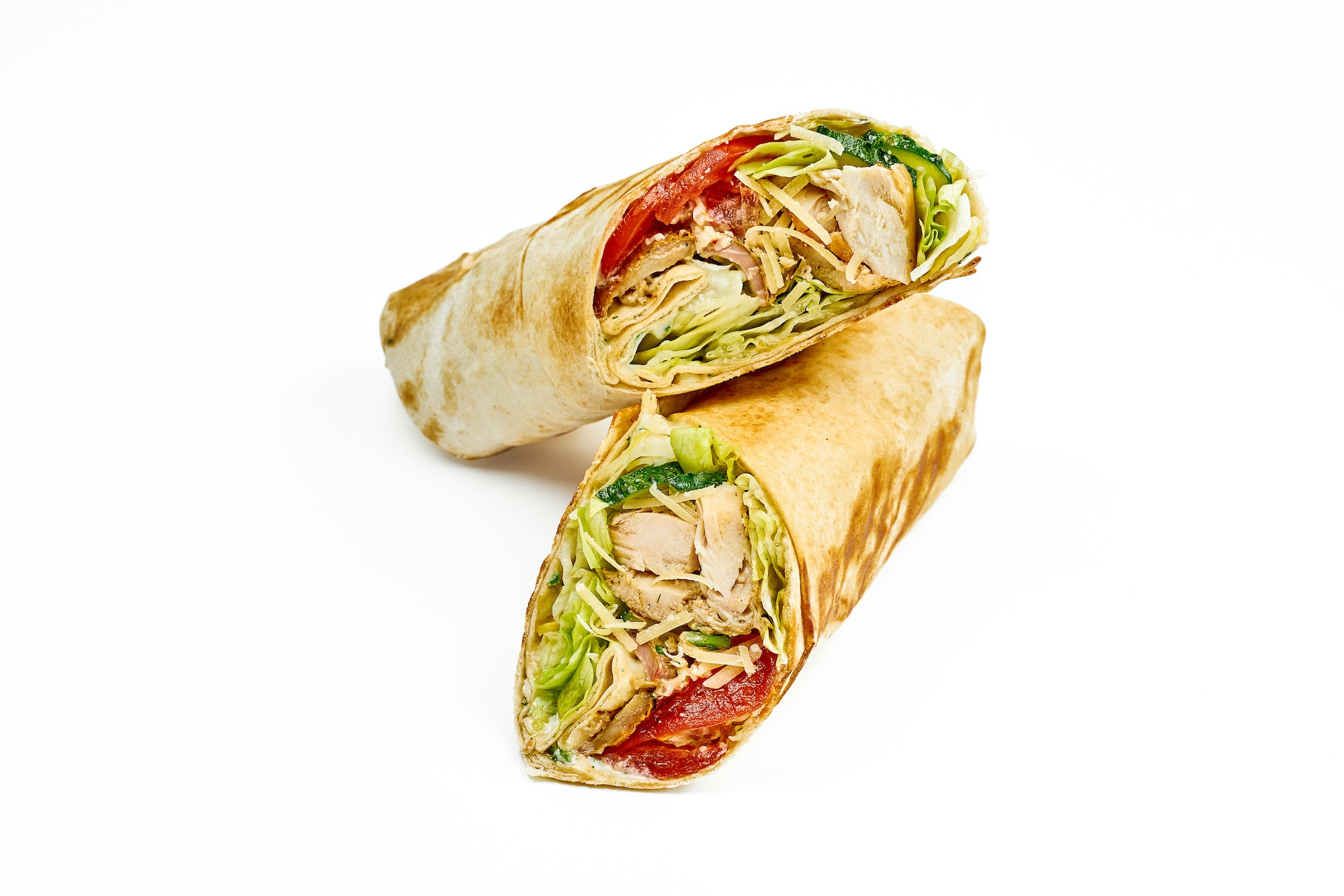Shawarma with chicken, vegetables and red sauce isolated on white background
